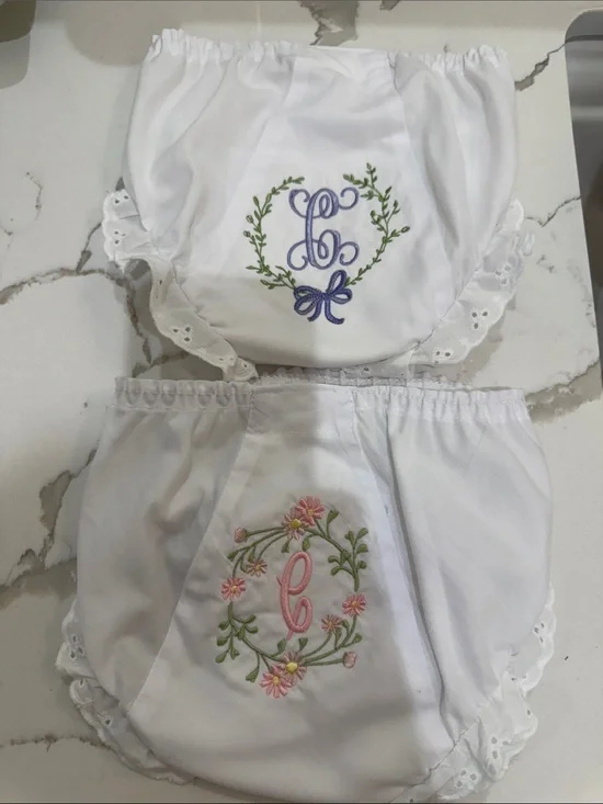 Pair of IC COLLECTIONS White Ruffle Diaper Covers w/ “C” Floral Monograms