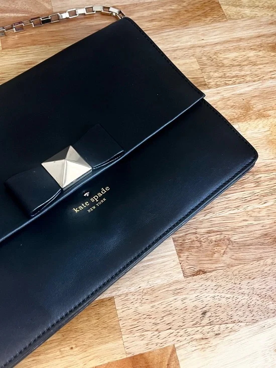 Kate Spade New York Black Leather Clutch Bag with Shoulder Strap and Bow Accent