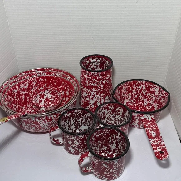 Vintage enameled tableware set with red splashes: rustic kitchen decoration
