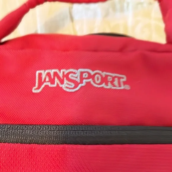 Red Jansport laptop messenger bag. Interior Velcro & outer zippered compartment