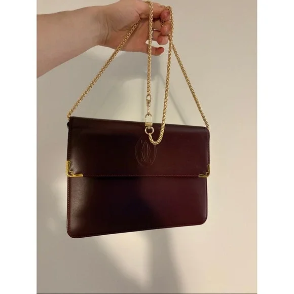 Cartier Burgundy Leather wristlet with Gold Corners