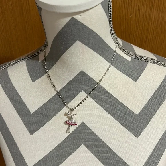 Kids 16” silver necklace with a 1.5” ballerina pendant. Gently used.