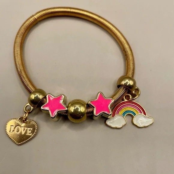 Yellow gold plated spring baby bangle with rainbow, heart and star charms.