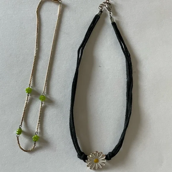 Fine gold tone chain with green flower spacer, yellow daisy w/blk leather cord