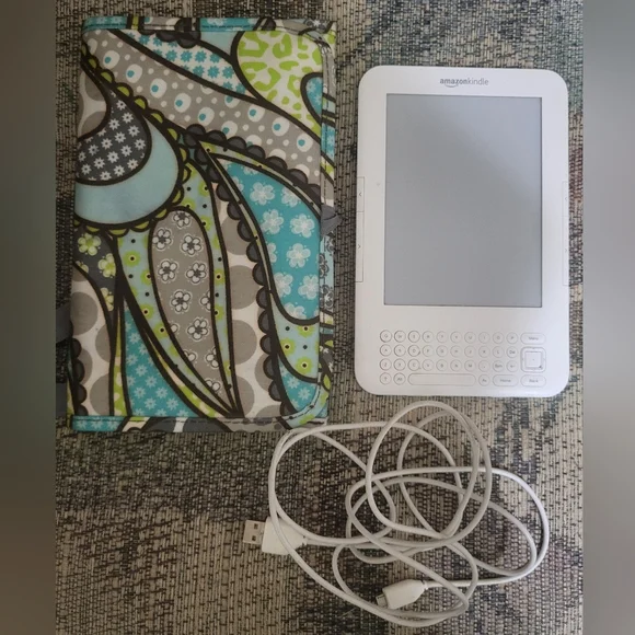 Amazon Kindle with charging cord and Thirty-one carrying case