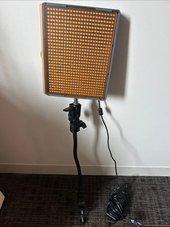 Aputure Amaran HR672W LED Video Light Panel with stand/holder and orange filter.