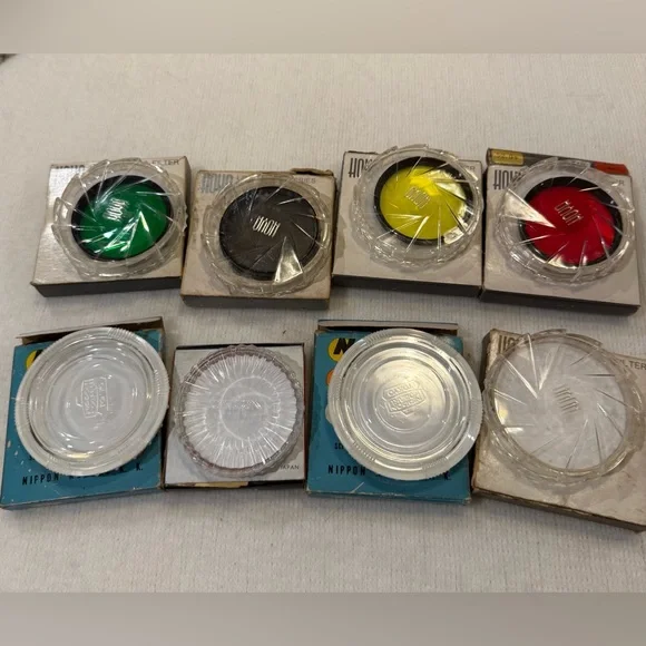 Lot of 4 Hoya photographic filters and 4 filter cases.