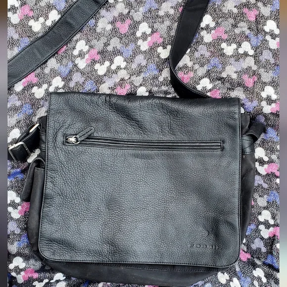 This is a Fossil 1954 organizer crossbody messenger bag in black leather.