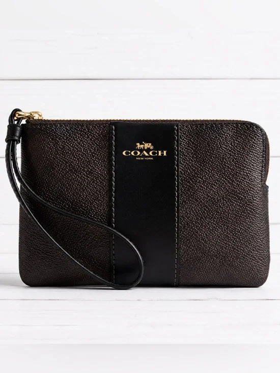 COACH corner zip wristlet in signature C pattern brown and black