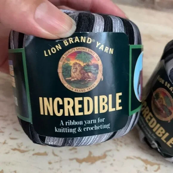 Lion brand incredible ribbon yarn in accent on black