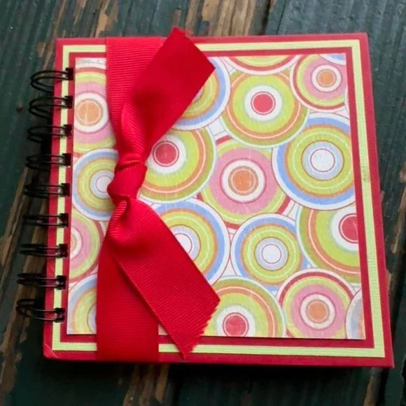 Red and yellow spiral website address book with ribbon