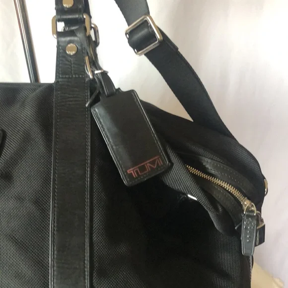 TUMI black Boston 2 way leather and canvas and mini lock. Detachable straps.