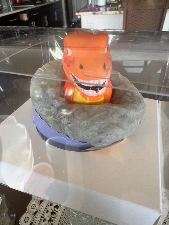 Hand Crafted Orange Dinosaur Bath Toy in Gray Nest