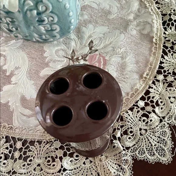 Chocolate brown toothbrush holder.‎