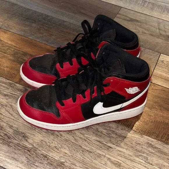 Nike Air Jordan 1 Mid in the black, white, and Gym Red