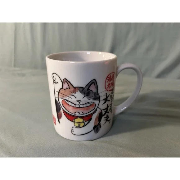 Egao Neko mug, a lucky charm featuring a smiling cat (Maneki Neko)