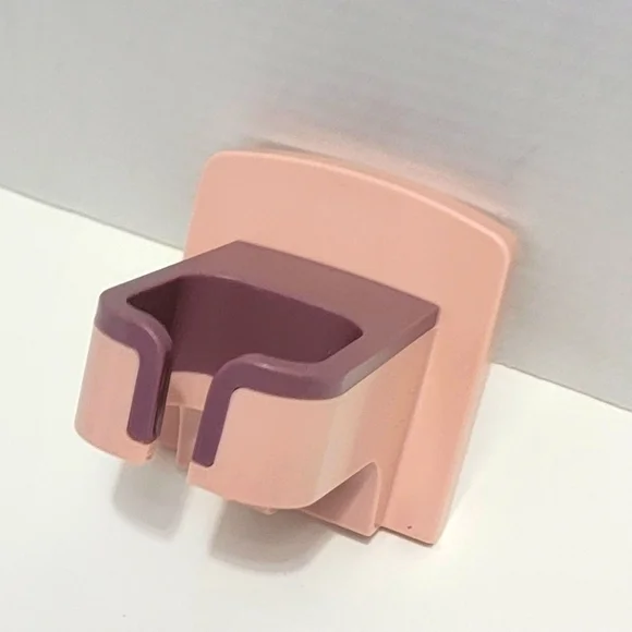 Pink and Purple Wall-Mounted Blow Dryer Holder.