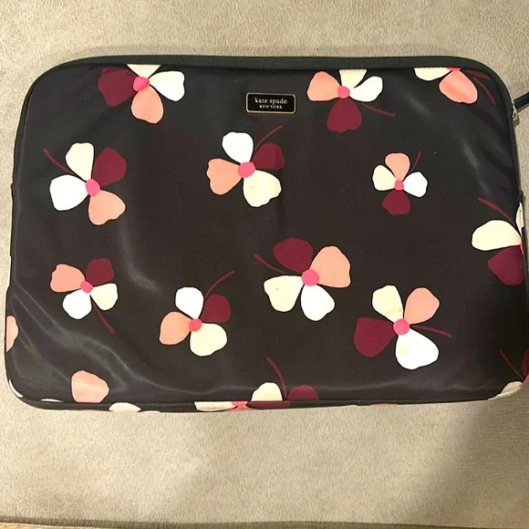 Laptop sleeve black with flower prints, small stain on bottom right