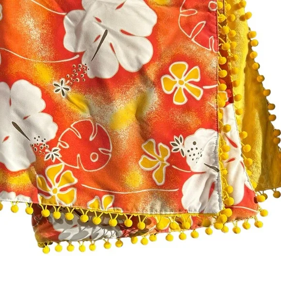 beach blanket in bright orange aloha print pom pom fringe