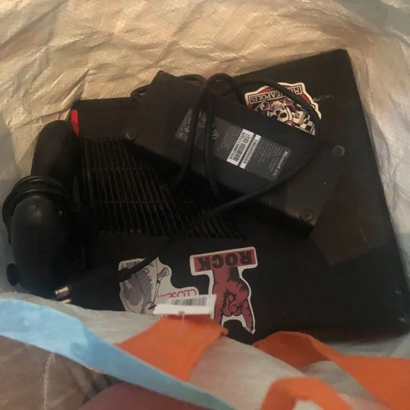 Black Gaming Console with Stickers Pick up in 314 E Loveland ave