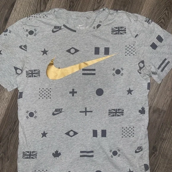 Nike Men's Gray Tee with Gold Swoosh and Flag Patterns