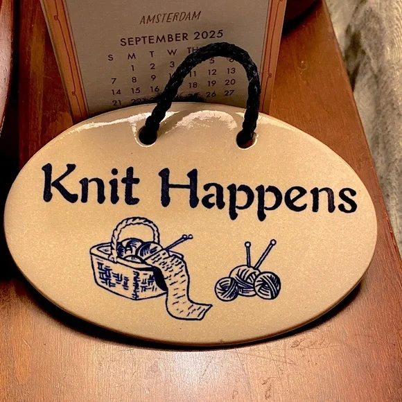 “Knit Happens” Hanging Plaque by Mountain Meadows Pottery. Features Yarn/Needles