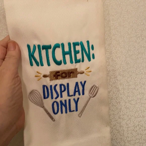 Embroidered kitchen towel “for display only”