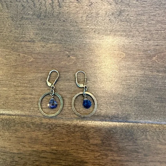 Silver toned dangle earrings with purple stone
