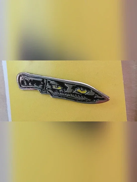 Black Blade Metal Lapel Pin with Yellow Eye Accents
