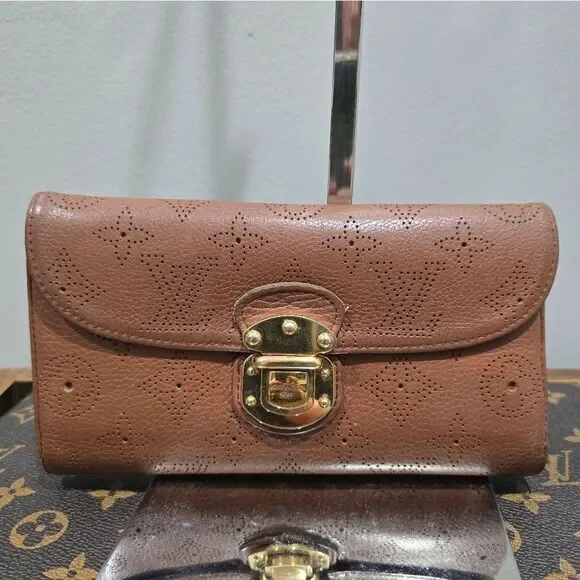 Authentic Louis Vuitton Mahina Amelia Wallet Monogram in brown leather.