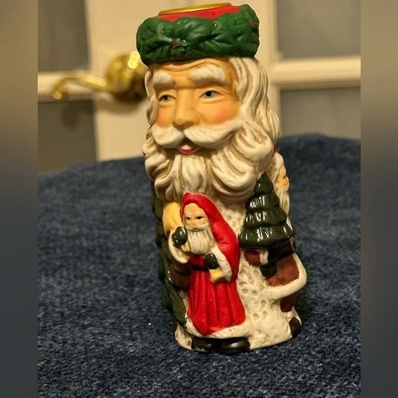 Set of 2 Santa candleholders. Each has smaller different smaller Santas.