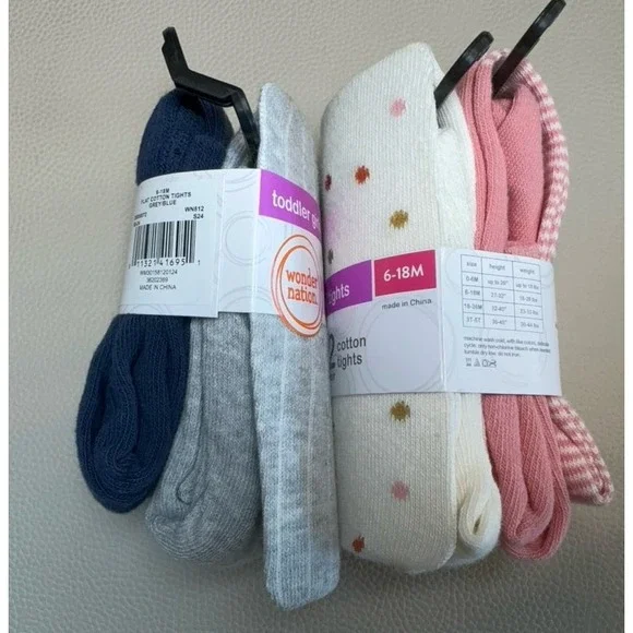 Four pairs of toddler girls cotton tights size 6-18 months.