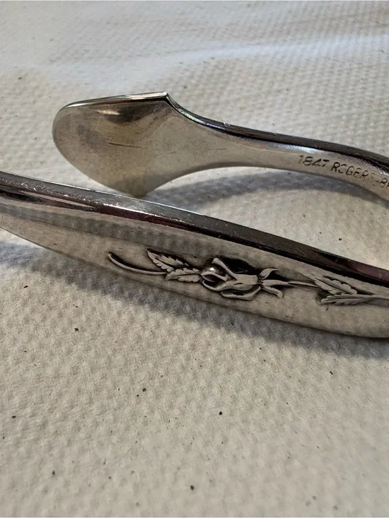 Silver 1847 Roger and bros set of six napkin clips.