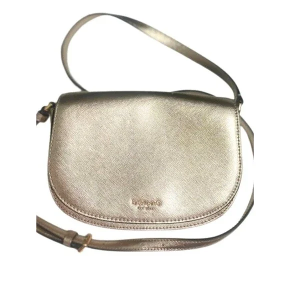 Kate Spade New York Paterson Court Crossbody Bag in Metallic Gold Finish.