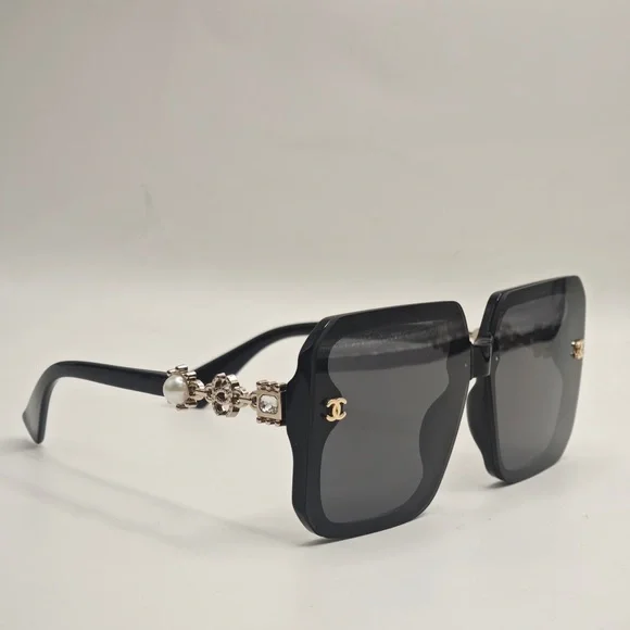 CHANEL Elegant Black Sunglasses with Gold Accents