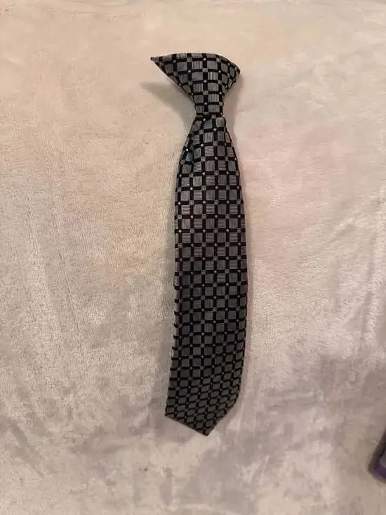 Boys clip-on necktie has a black silver gold checkered pattern 10”