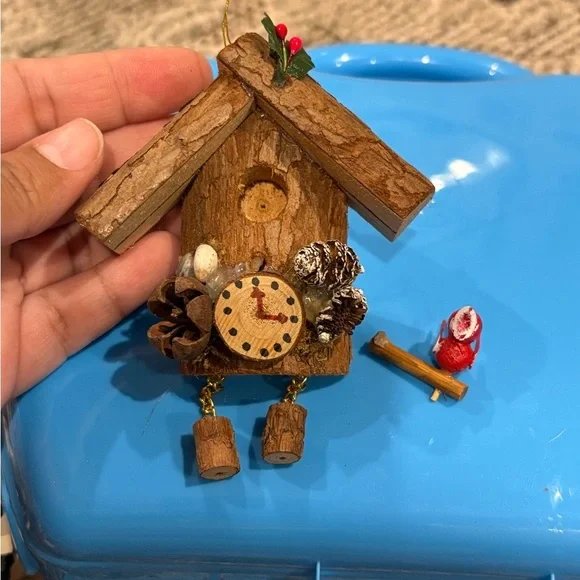 Christmas ornament depicting a wooden bird house clock