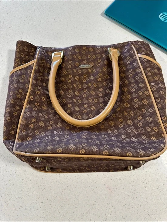 This is a brown Pierre Cardin monogram logo tote bag with beige leather handles.