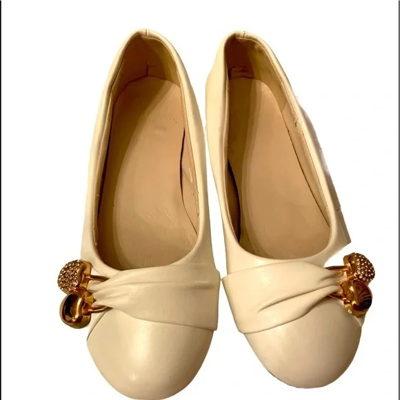 White Shoes with Hearts Decoration on them.