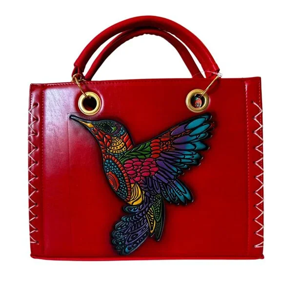 Tooled multicolored hummingbird on a vegan leather red satchel with make up bag