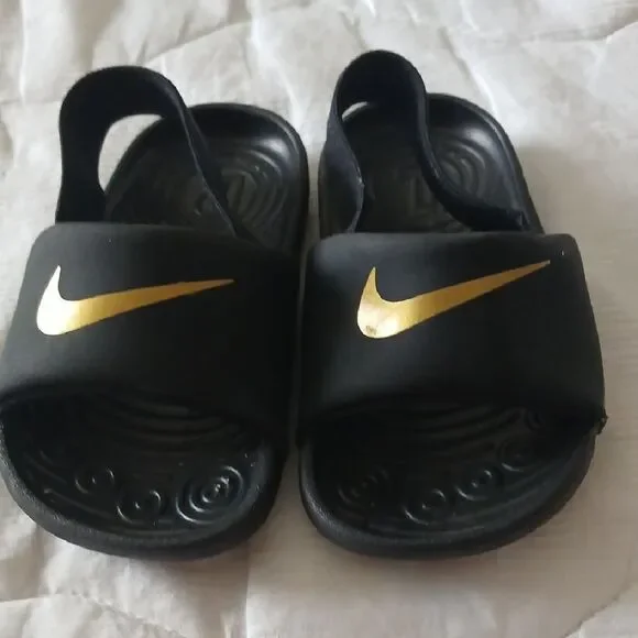 Nike Black and Gold Slide Sandals with Textured Footbed