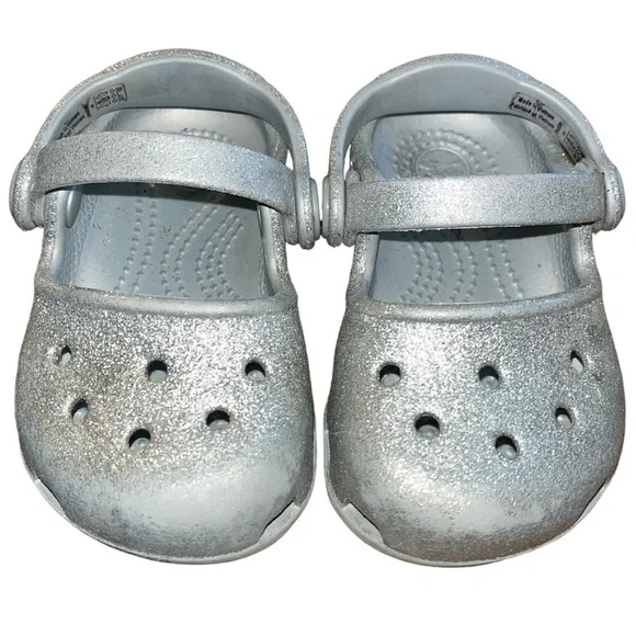 Baby’s silver glitter Crocs.  Baby’s size 4