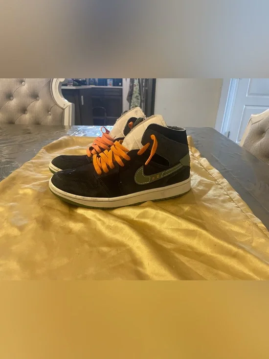 Nike Black High-Top Sneakers with Orange Laces and Green Swoosh