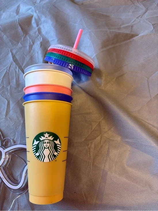 Starbucks Yellow Tumbler with Stack of Colorful Interchangeable Lids