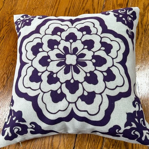 Square cream color 18” throw pillow.  Blue/purple design on one side.
