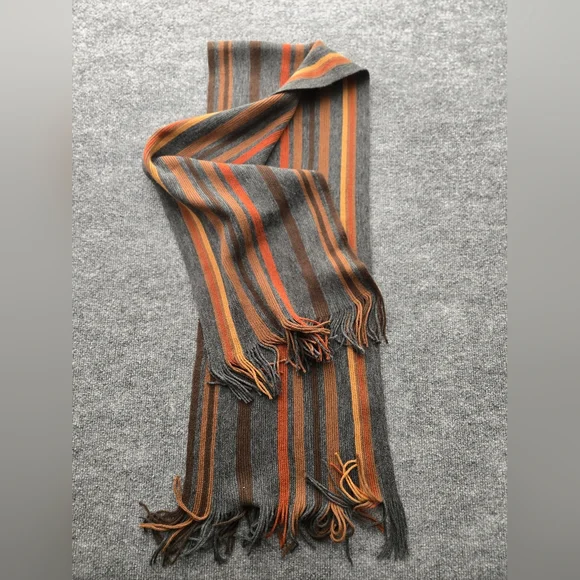 Womens Scarf featuring multicolor stripes and fringe ends. Perfect Pop Of Color‎