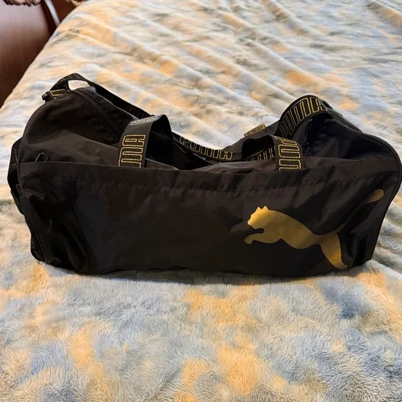 Puma Black Duffel Bag with Gold Puma Logo and Branded Straps