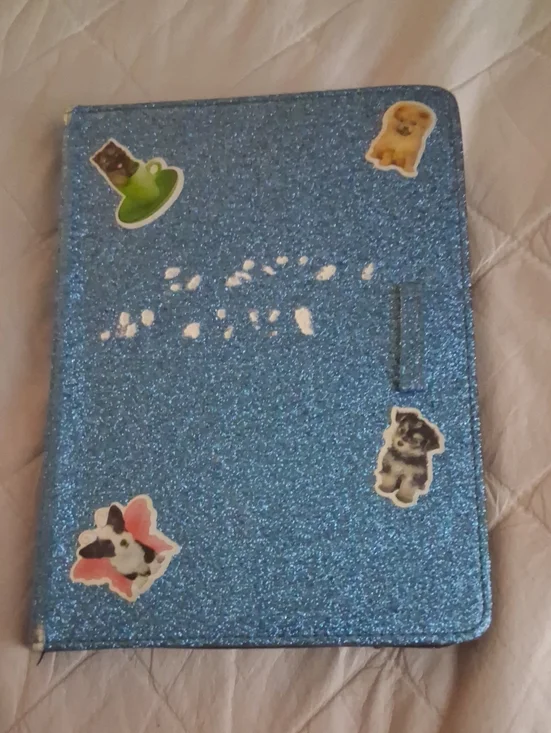 Amazon Kindle with blue case with stickers on