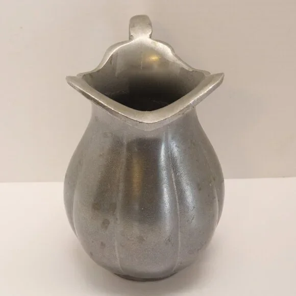 A Heavy Pewter Water Pitcher Pre Owner with some signs of wear