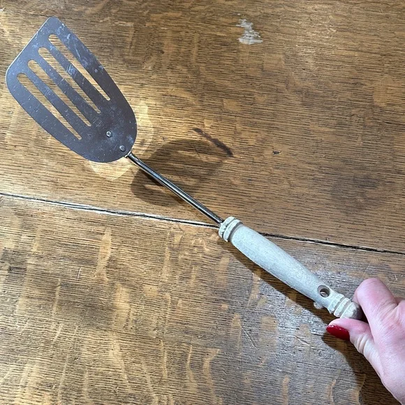 vintage Ekco Slotted‎ Turner Spatula with a white wood handle.